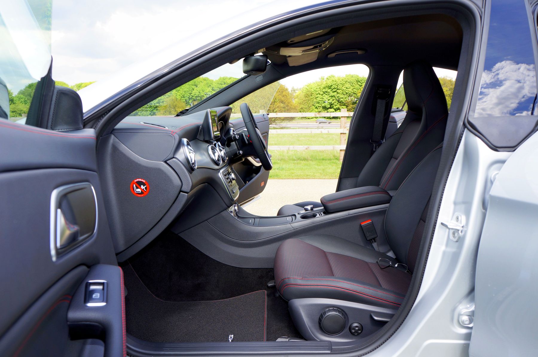 Clean vehicle interior viewed through an open driver door